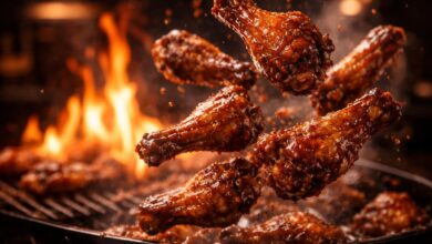 sizzling chicken wings being tossed in rich glossy sauce